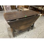 An antique oak dropleaf table with frieze drawer on turned legs. 39' wide