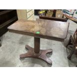 An early Victorian mahogany reading table on facetted column and quadripartite platform support.