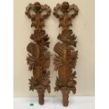 A pair of 19th century French pine wall appliques, carved with foliage with ribbon-tie surmounts.