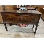 An 18th century oak dresser base with two drawers, raised on square legs. 50' wide