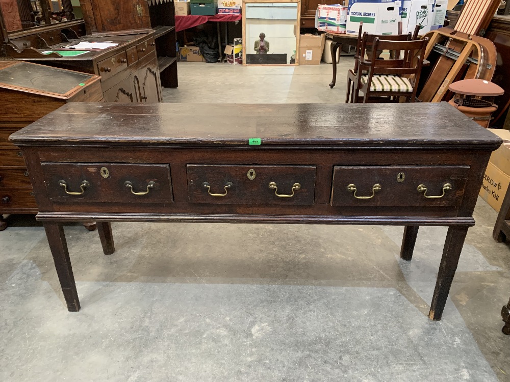 A George III decorated pine dresser base in original finish, the moulded top over three drawers,