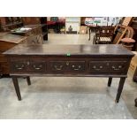 A George III decorated pine dresser base in original finish, the moulded top over three drawers,