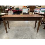 An antique carved mahogany serving table with two frieze drawers, raised on square tapered legs with