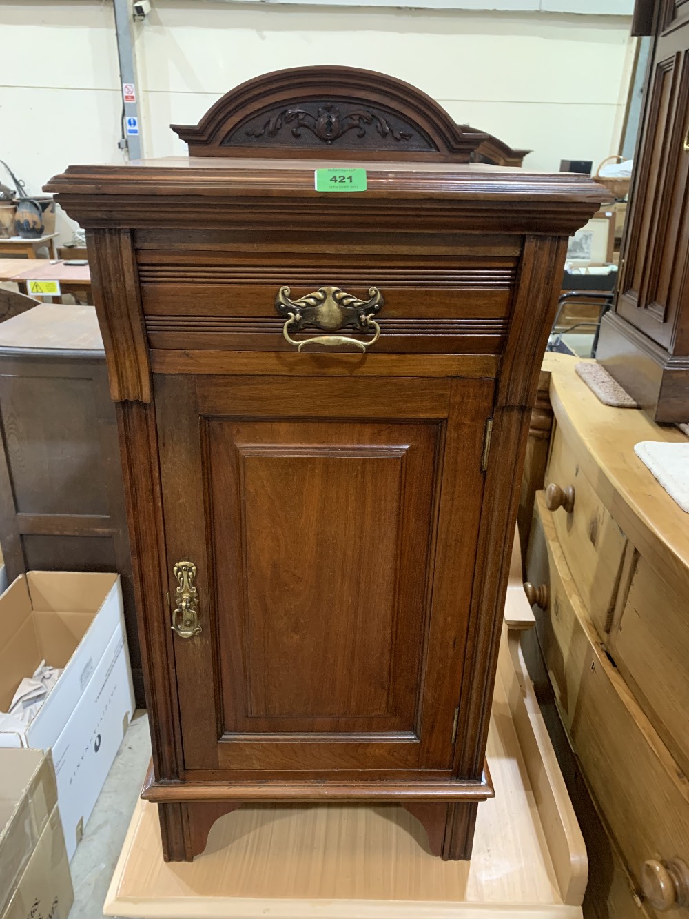 A late Victorian walnut bedside cabinet with frieze drawer