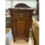 A late Victorian walnut bedside cabinet with frieze drawer