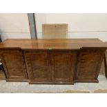A 19th century mahogany breakfronted buffet, the four ripple grained doors enclosing an