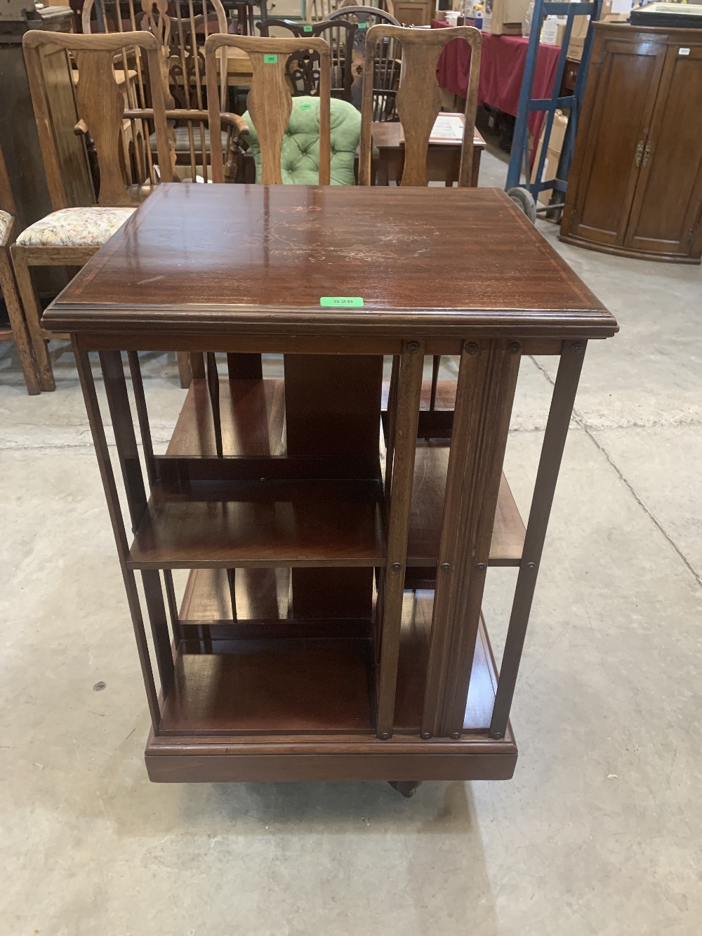 A late Victorian mahogany and inlaid revolving bookcase. Bears a label for W.F. Greenwood + Sons,