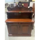 A mahogany chiffonier with raised back over a pair of frieze drawers and conforming cupboard