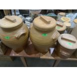 Four earthenware storage jars with beechwood covers, the larger 16½' high.
