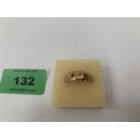 An Edward VII three stone ring. In gold marked 15. 3g gross. Size O.