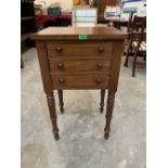 A 19th century mahogany pot cupboard enclosed by a false drawer front door on ring turned legs