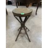 An industrial metal stool