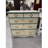 A 19th century decorated pine chest of two short over three long drawers on shaped plinth support.