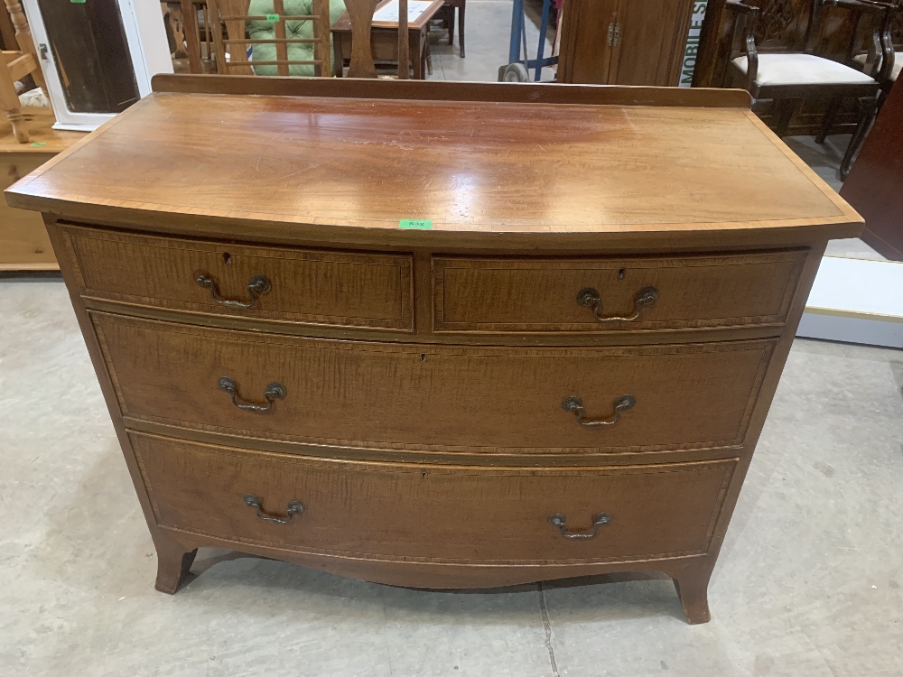 An early 20th century mahogany and banded bowfronted chest of two short over two long drawers on