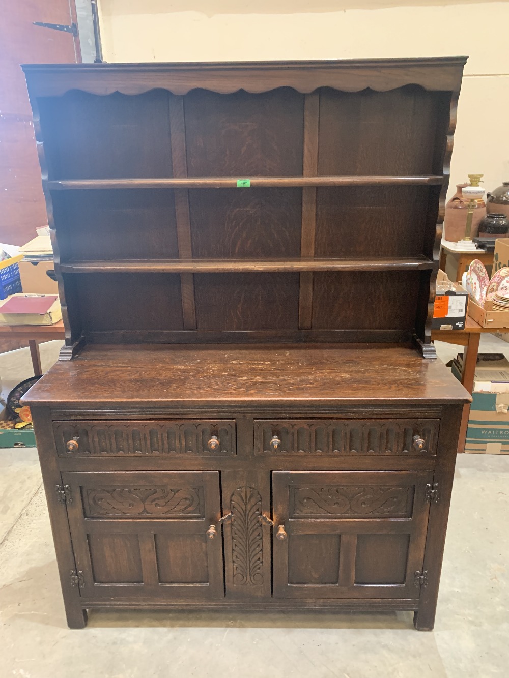 An oak dresser with two carved drawers over two cupboard doors. 48' wide