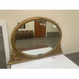 A 19th century gilt gesso overmantle mirror with oval plate. 49' x 32½' h