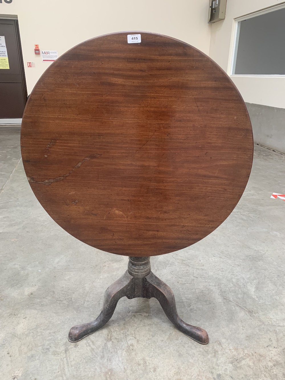 A George III mahogany tripod table, the one piece snap-top on baluster column with birdcage. 30½'