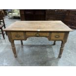 A 19th century pine desk with three drawers on turned legs. 48' wide