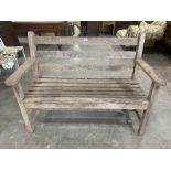 A wood slatted garden bench. 47' wide