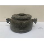 An archaic green stone vessel and cover with stylised horse head handles 9' diam x 4¼' high. Signed