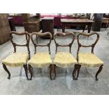 A set of four Victorian rosewood salon chairs with compressed balloon backs. Repairs