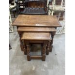 A nest of three oak occasional tables