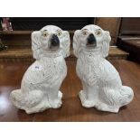 A pair of 19th century Staffordshire spaniels with yellow eyes and gilt decoration. 14' high