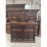 A 17th century and later joined oak carved livery cupboard, the upper part with denticular