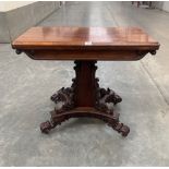 A 19th century rosewood card table, the fold-over green baize lined top on scroll and foliate carved