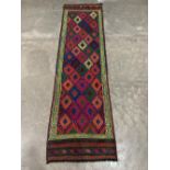 A Suzni Kilim carpet runner. 2.22m x 0.62m