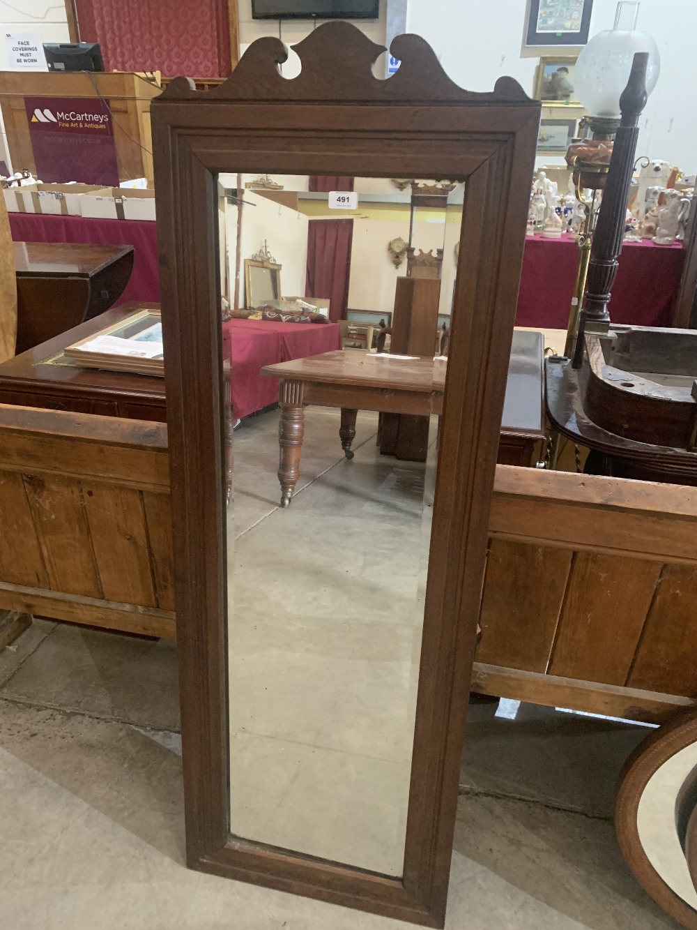 An oak framed wall mirror with bevelled plate. 58' high