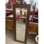 An oak framed wall mirror with bevelled plate. 58' high