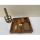 A Victorian lacquered brass Culpeper type microscope, the stage ratchet focussing on two legs over a