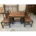 A mid 20th century oak drawleaf dining table and four chairs
