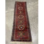 A Persian red ground carpet runner. 78' x 26½'