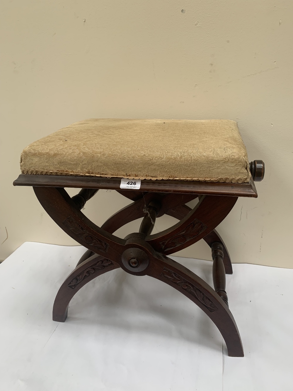 A Victorian X-framed walnut piano stool, the seat adjustable for height. 18' wide