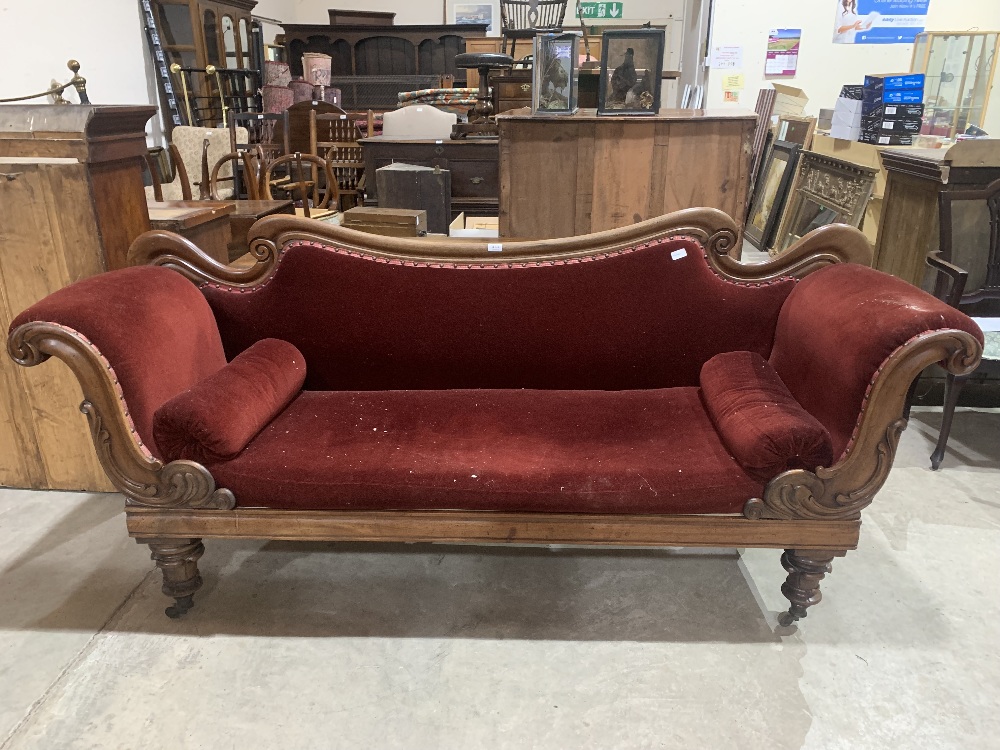 An early Victorian mahogany sofa with shaped scrolled back and acanthus carved arms, on turned