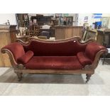 An early Victorian mahogany sofa with shaped scrolled back and acanthus carved arms, on turned
