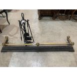A Victorian 50' cast iron and brass rail fender together with a wrought iron companion set.