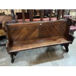 A Victorian pitch pine gothic carved church pew. 66' long