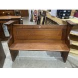 A 19th century pitch pine church pew. 54' long