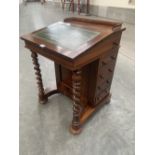 A Victorian rosewood davenport, the sloping leather inlet fall enclosing a walnut, maple and