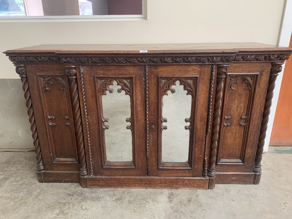 A 19th century oak gothic revival breakfronted side cabinet in the manner of Augustus Welby