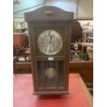 A 1930s oak wall clock with two train movement