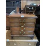 An early 20th century mahogany music chest of four fall-front drawers. 20' high