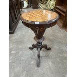 A Victorian inlaid walnut trumpet work table the chessboard and foliate marquetry lid enclosing a