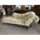 A Victorian chaise-longue with shaped button back and arm. Rear leg detached