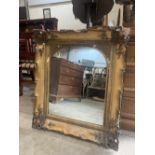 A 19th century gilt gesso looking glass with arched plate. 33' high. Losses