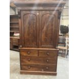 A Victorian mahogany linen press, the flame veneered arch panel doors enclosing five sliding