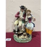 A Staffordshire group of a gentleman playing a pipe with lady companion, hound and goat. 10' high